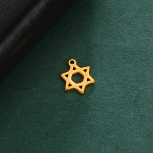 Classic gold hexagram pendant in stainless steel with a polished finish on green surface