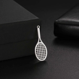 Detailed view of silver stainless steel tennis racket pendant on a premium black gift box