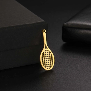 Macro detail of a hollow gold stainless steel tennis racket pendant for jewelry making