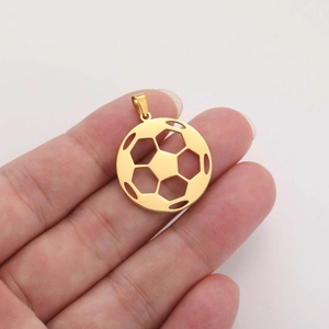 Hollow gold football pendant in stainless steel held to show scale and detailed sports design