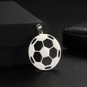 Detail shot of a hollowed-out soccer ball pendant on a textured black gift box
