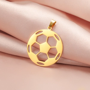 Detailed view of a gold hollow football pendant with geometric patterns on pink satin