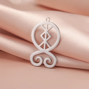 Polished silver stainless steel Troll Cross pendant on soft pink satin fabric