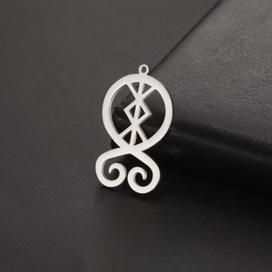 Macro view of silver stainless steel Troll Cross pendant with hollow Nordic runes