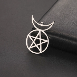 Polished stainless steel pentagram and moon pendant on a black leather surface
