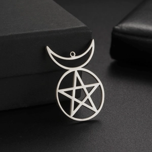 Macro detail of silver stainless steel crescent moon and pentagram star charm pendant