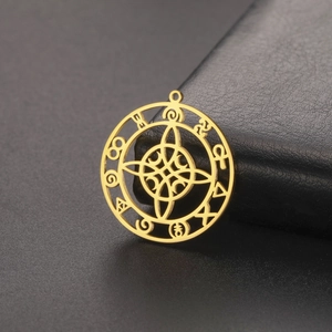 Macro shot of gold Celtic knot charm with mystical runes for DIY jewelry