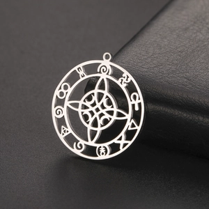 Detailed macro view of silver steel witch knot pendant with occult symbols on black leather