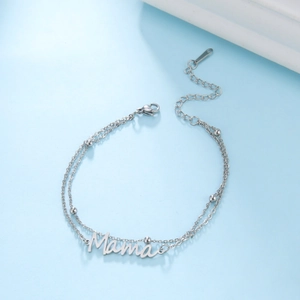 Detalle de pulsera de cadena doble plateada con colgante de Mama y pequeñas bolas