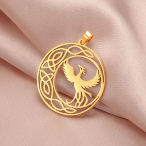 Detail of a gold phoenix celtic knot round pendant on a silk satin background