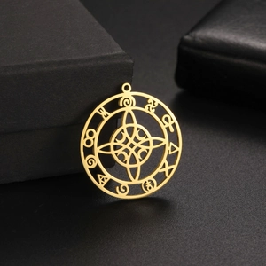 Macro view of gold Celtic knot pendant with mystical symbols on black background