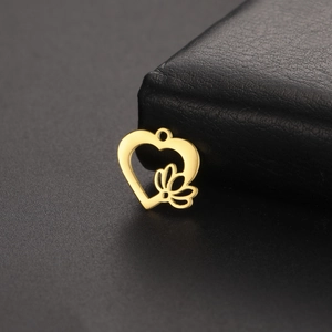 Vue détaillée du pendentif cœur en acier doré ajouré avec motif floral sur cuir