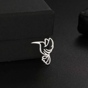 Macro shot of silver hummingbird pendant resting on a premium black matte jewelry box