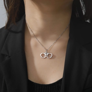 Hip hop handcuff pendant necklace for couples in polished silver finish on model