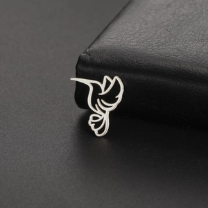 Polished stainless steel hollow hummingbird pendant displayed on black jewelry box