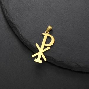 Polished gold stainless steel Chi Rho religious pendant on a black stone background