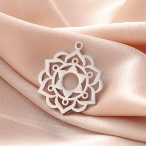 Polished stainless steel mandala sun pendant with hollow design on champagne silk