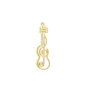Macro view of gold-plated guitar and treble clef music pendant with hollowed detail