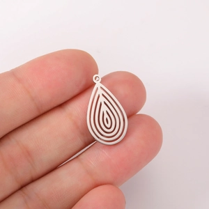 Macro shot of silver stainless steel teardrop pendant with multi-layer hollow design