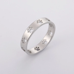 Macro detail of the polished silver stainless steel ring with hollow cat paw cutouts