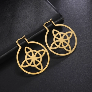 Macro detail of gold-plated stainless steel hoop earrings with intricate Celtic knot patterns