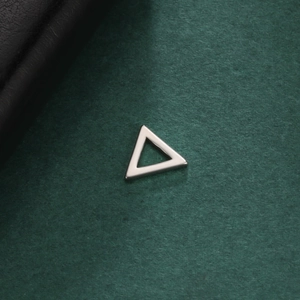 Macro view of geometric hollow triangle pendant with polished silver finish