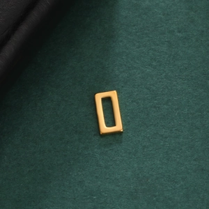 Macro view of a 18K gold plated hollow rectangular geometric pendant on black leather