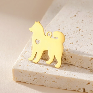 Golden shiba inu dog charm with heart cutout on travertine stone for DIY jewelry