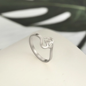 Macro detail of silver stainless steel ring featuring cutout Hindu Om religious symbol