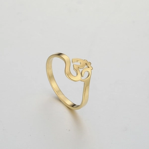 Close-up of gold-plated titanium steel ring featuring an Om yoga symbol engraving