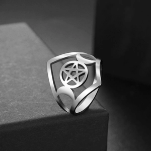 Macro detail of stainless steel ring featuring cutout pentagram and crescent moon design