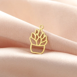 Close-up of a gold minimalist potted succulent pendant on pink satin background