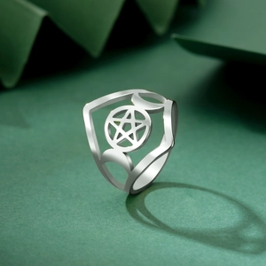 Macro detail of silver stainless steel ring with pentagram and moon phase design