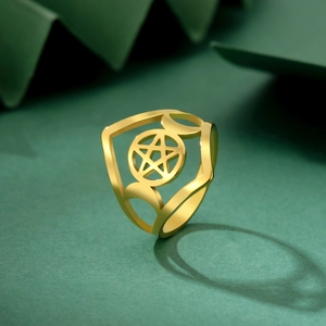 Detail of golden stainless steel ring featuring cutout pentagram and moon phases symbols