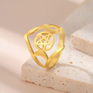 Macro detail of golden stainless steel pentagram ring with moon design on stone