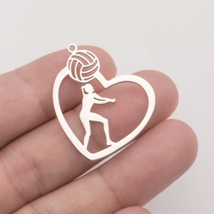 Detailed view of heart-shaped stainless steel volleyball player pendant in hand
