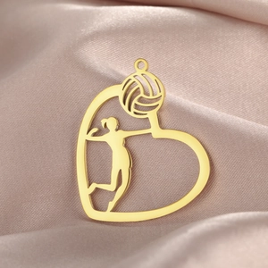 Macro shot of a golden heart volleyball pendant featuring an athlete on purple satin