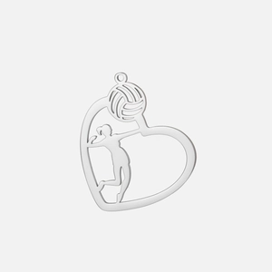 Macro detail of a volleyball heart pendant featuring a player silhouette in silver steel