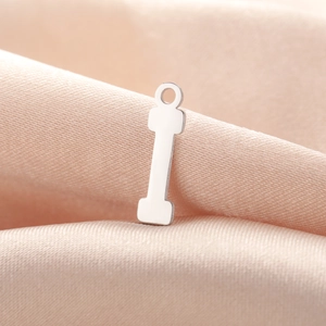 Polished silver stainless steel dumbbell pendant showing smooth edges and a top hanging hole