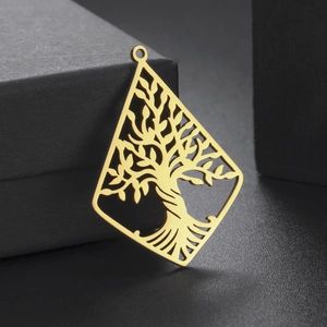 Macro detail of a golden diamond-shaped Tree of Life pendant in polished stainless steel