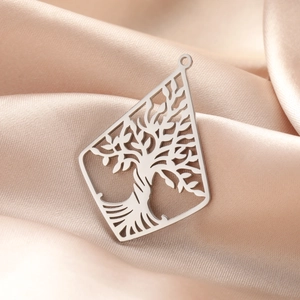 Polished silver stainless steel Tree of Life pendant with cut-out design on silk background