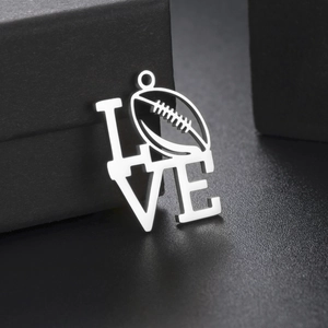 Dettaglio del ciondolo LOVE in argento con motivo rugby su scatola porta gioie nera
