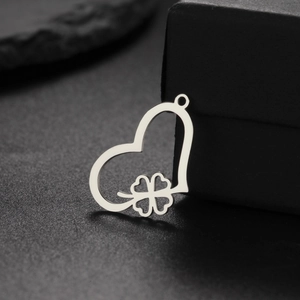 Silver hollow heart clover pendant crafted in stainless steel on black jewelry box