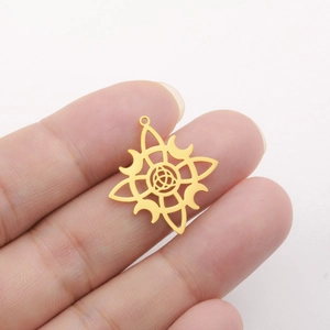 Pendentif carré nœud celtique en acier doré avec motif d'étoile tenu dans la main