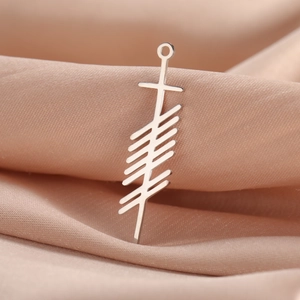 Close-up of a silver stainless steel vertical bar pendant with Ogham rune symbols