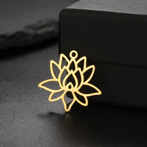 Detailed close-up of a gold lotus charm pendant on a premium black textured surface
