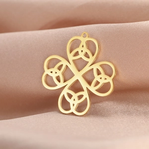 18K gold plated stainless steel Celtic knot clover pendant on elegant pink silk background