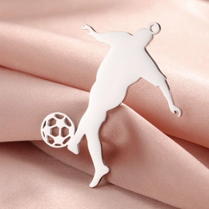 Polished silver football player pendant necklace on soft pink silk background