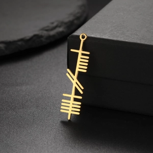 Golden stainless steel pendant with Ogham linear symbols shown on a black gift box