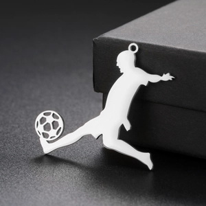 Polished stainless steel soccer player pendant in action pose on a black background